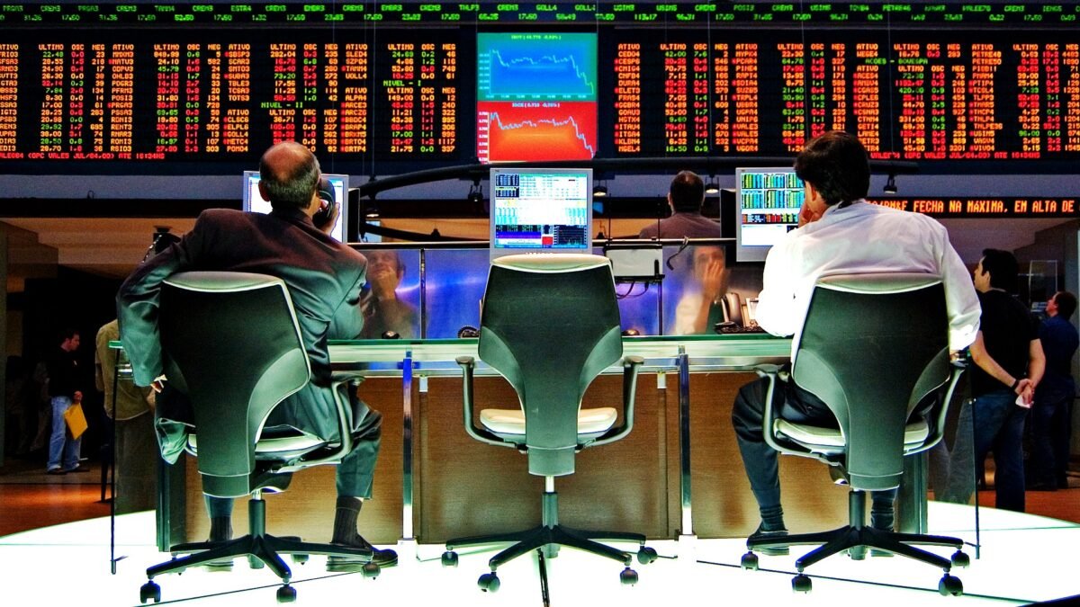 File photo: traders at desks beneath the electronic price board on the Bovespa trading floor in São Paulo.