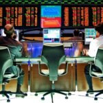 File photo: traders at desks beneath the electronic price board on the Bovespa trading floor in São Paulo.