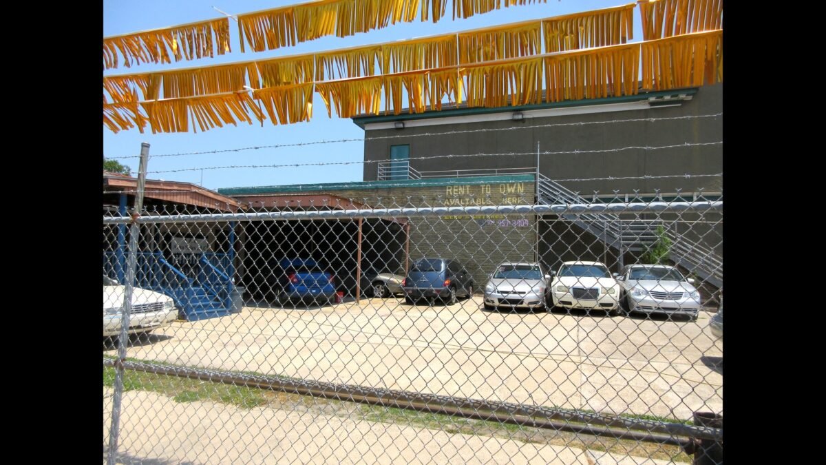 File photo: rows of used cars for sale on a lot in Mid-City, New Orleans.