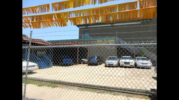 File photo: rows of used cars for sale on a lot in Mid-City, New Orleans.