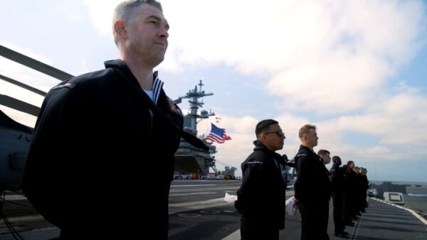 File photo: sailors man the rails aboard the aircraft carrier USS George Washington in the Atlantic Ocean in April 2024.