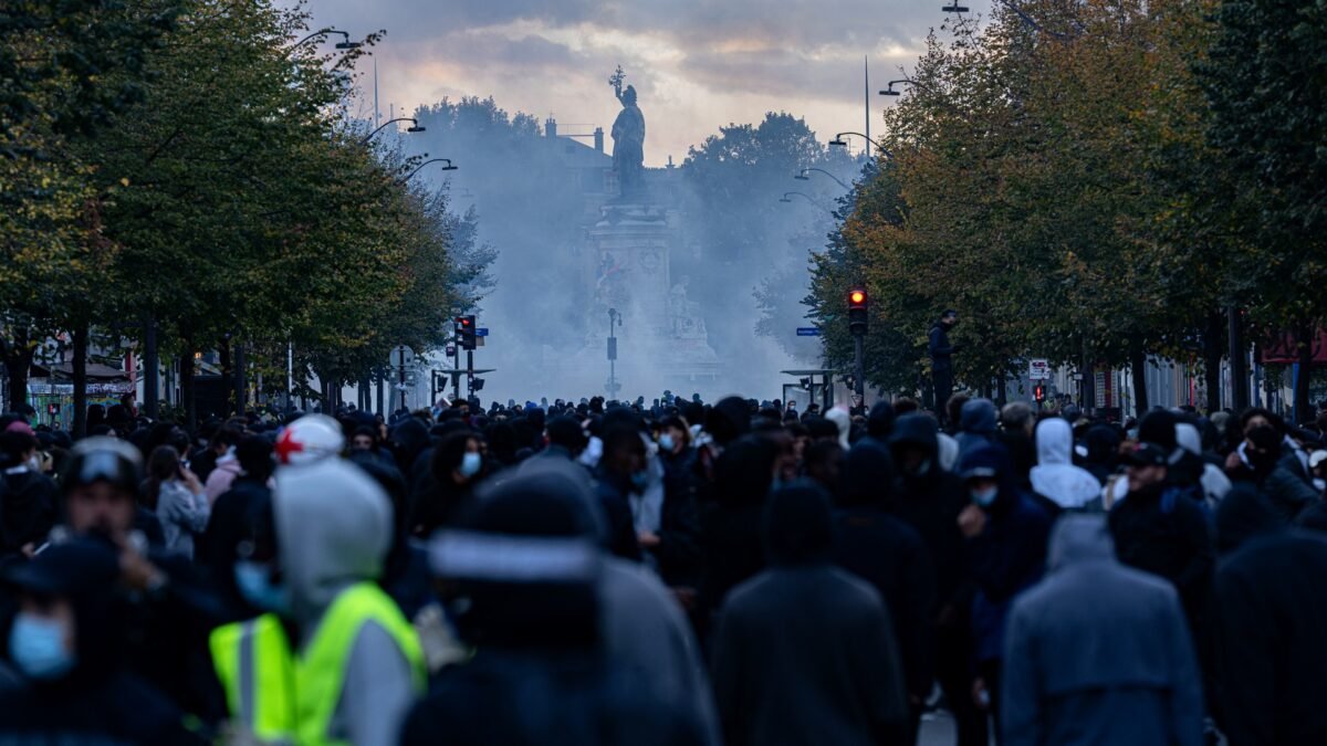 File photo: a large crowd at Place de la République in Paris during protests on 17 October 2026, with tear gas in the air.