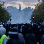 File photo: a large crowd at Place de la République in Paris during protests on 17 October 2026, with tear gas in the air.