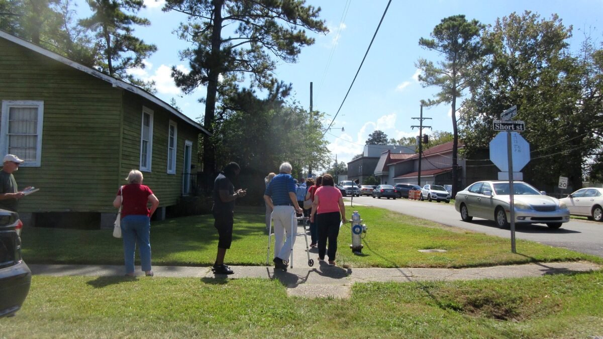 File photo: Voters queue on a sidewalk outside the Jefferson Parish Registrar of Voters office in Kenner, Louisiana, in October 2020.