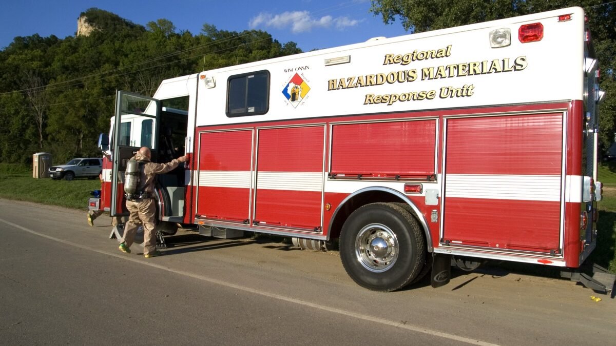 File photo: a firefighter in a hazmat suit climbing into a regional hazardous materials response unit in the US Midwest.