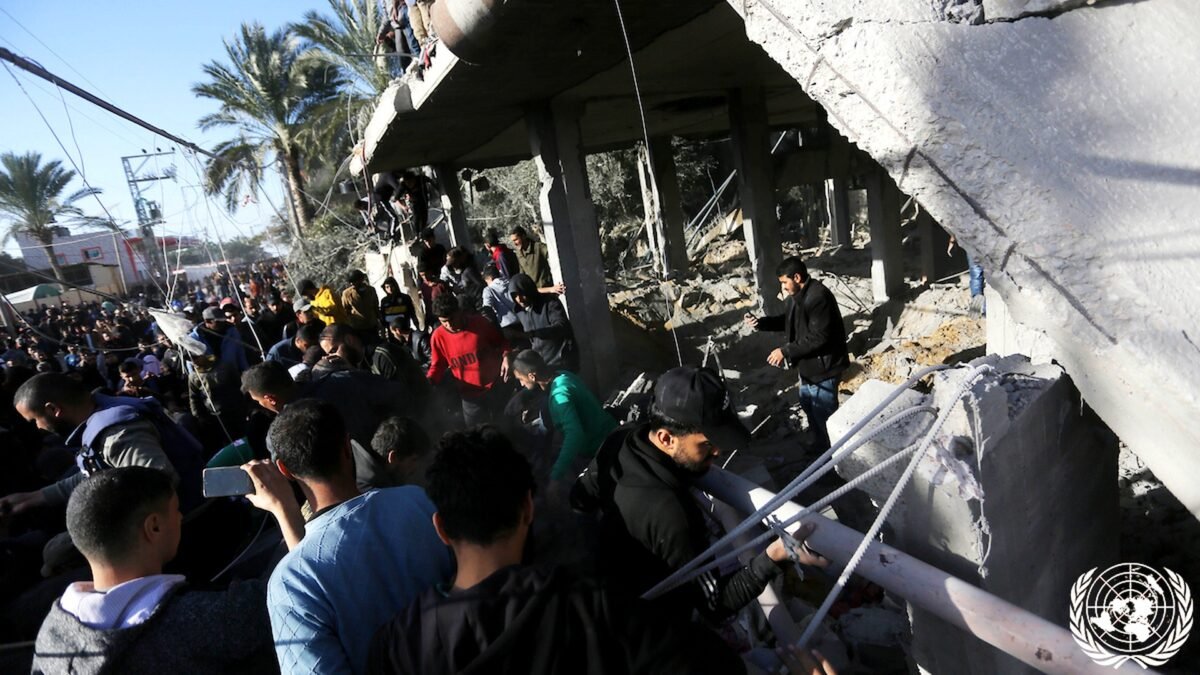 File photo: Palestinians search through rubble of a destroyed building in Deir el-Balah, Gaza Strip.