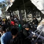 File photo: Palestinians search through rubble of a destroyed building in Deir el-Balah, Gaza Strip.