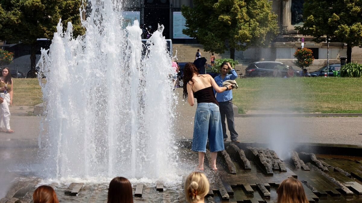 File photo: people cool off at the Lustgarten fountain in Berlin, Germany, during the June 2026 heatwave.