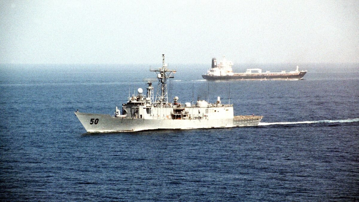 File photo: an oil tanker transits the Strait of Hormuz as the frigate USS Taylor passes.