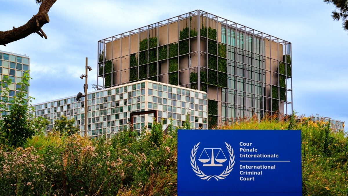 The International Criminal Court building in The Hague, Netherlands, with the court's official sign in the foreground.