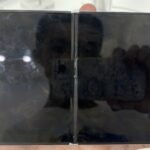 An open iPhone Duo foldable phone held in a hand, showing the unfolded tablet-sized inner display with its center hinge.