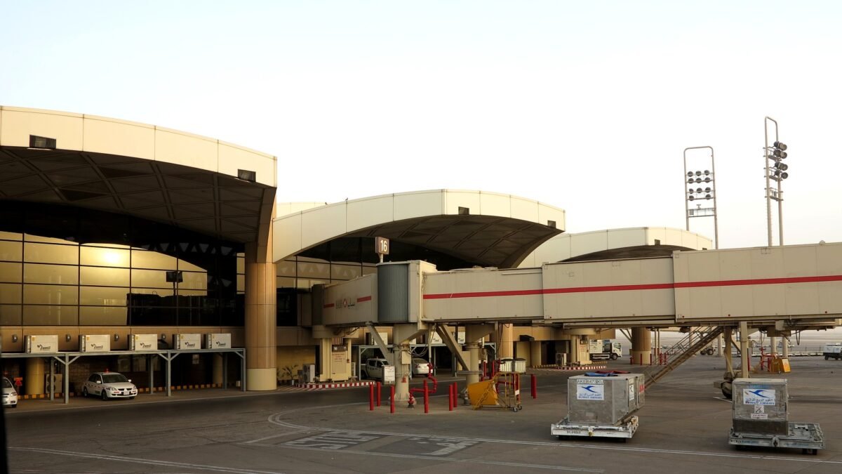 File photo: Terminal 1 at King Khalid International Airport in Riyadh, with a jet bridge and cargo dollies on the apron.