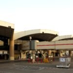 File photo: Terminal 1 at King Khalid International Airport in Riyadh, with a jet bridge and cargo dollies on the apron.