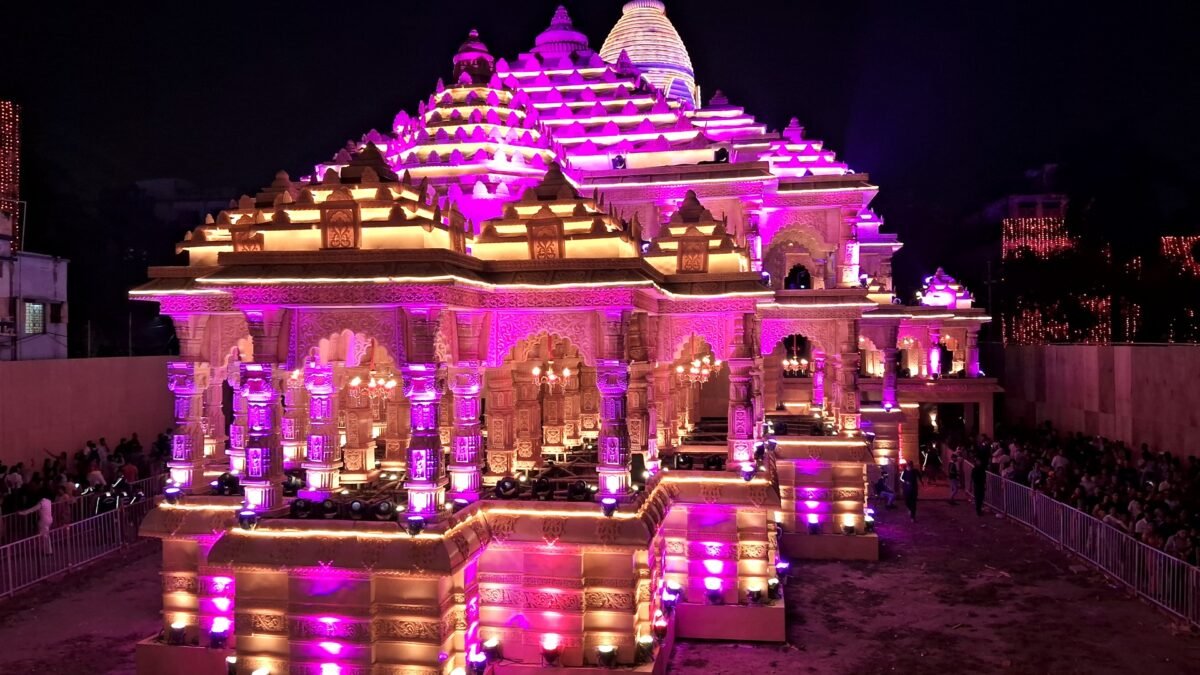 File photo: a crowd queues at an illuminated Durga Puja pandal in Kolkata at night.