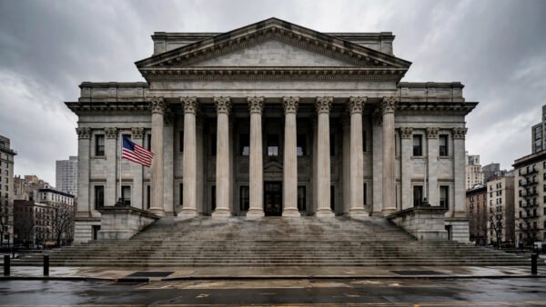 Grand neoclassical federal courthouse facade in Manhattan with an American flag flying, overcast daytime sky