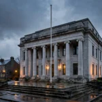 Stone courthouse with columns at dusk, where former DUP leader Jeffrey Donaldson was sentenced to 15 years for child sex offences
