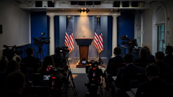 The White House press briefing room with an empty podium, American flags and television cameras