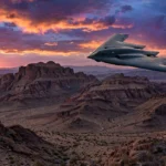 B-2 Spirit stealth bomber flying at dusk over desert mountains — illustration for the story on Trump's "leakers should be shot" remarks about the alleged Iran strike leak.