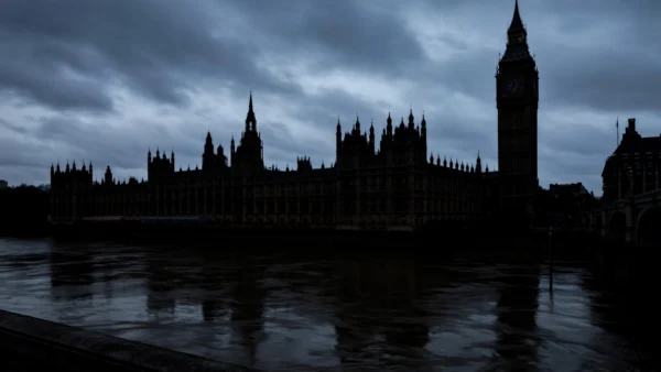The Houses of Parliament in Westminster, London, at dusk under a dark sky