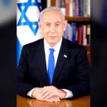 Benjamin Netanyahu, Prime Minister of Israel, in his official portrait of February 2023, seated at a desk with the Israeli flag behind him. File photo, not taken on election night.
