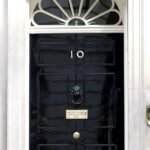 The black front door of 10 Downing Street, London, bearing the number 10 — the official residence where National Security Adviser Jonathan Powell serves.