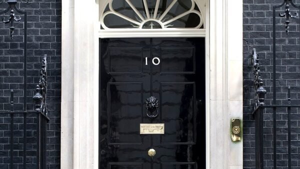 The black front door of 10 Downing Street, London, bearing the number 10 — the official residence where National Security Adviser Jonathan Powell serves.