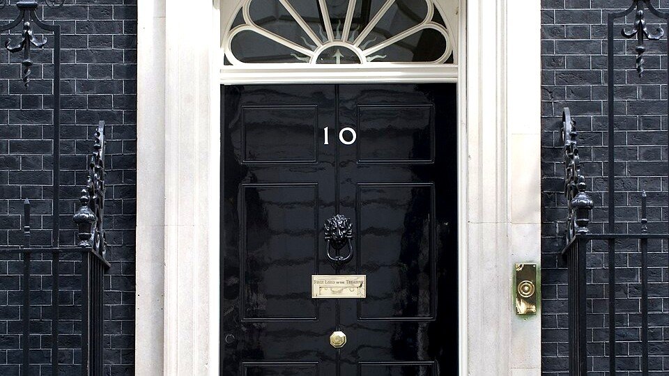 The black front door of 10 Downing Street, London, bearing the number 10 — the official residence where National Security Adviser Jonathan Powell serves.