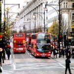 File photo: red double-decker buses and shoppers on Oxford Street in London, with the Selfridges building in the background, in December 2006.