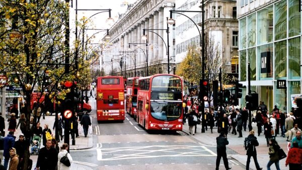 File photo: red double-decker buses and shoppers on Oxford Street in London, with the Selfridges building in the background, in December 2006.
