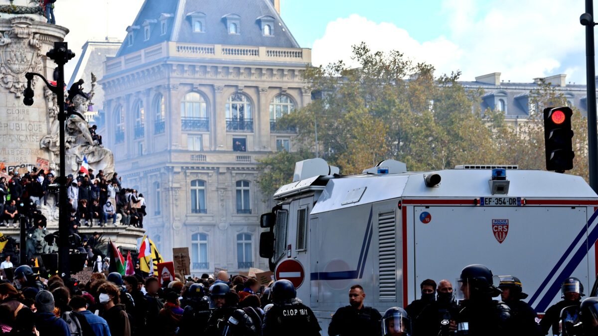 File photo: Protesters at the Place de la République in Paris with riot police and a CRS water-cannon vehicle during the October 2026 youth-led demonstrations.