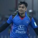 Rashid Khan celebrating a wicket for Afghanistan in his blue team jersey.
