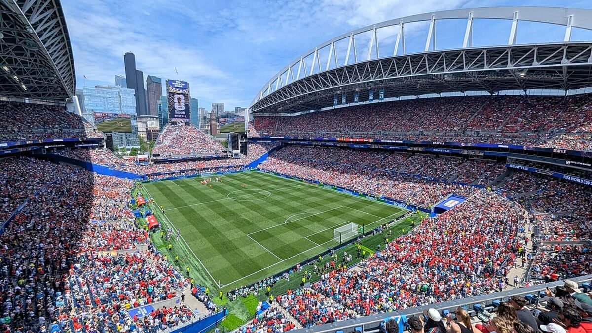 Lumen Field in Seattle, home of the Seattle Seahawks, packed with fans under a blue sky