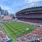 Lumen Field in Seattle, home of the Seattle Seahawks, packed with fans under a blue sky