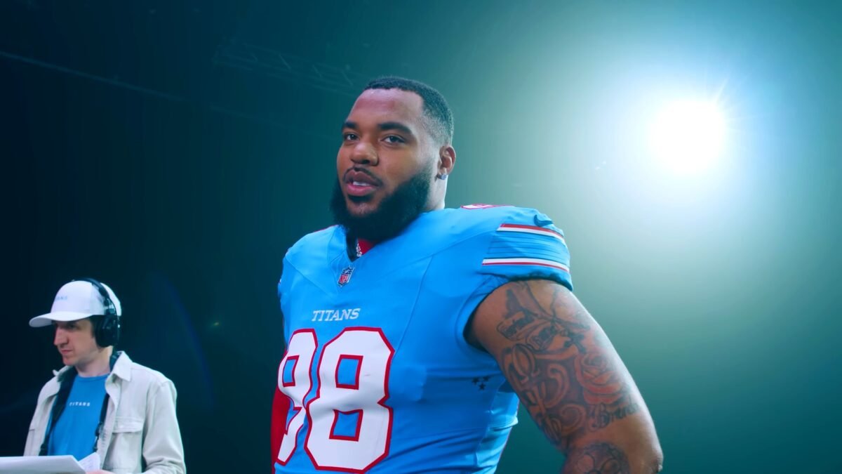 Jeffery Simmons in a light blue Tennessee Titans No. 98 jersey during the team's new jersey photo shoot in March 2026.