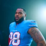 Jeffery Simmons in a light blue Tennessee Titans No. 98 jersey during the team's new jersey photo shoot in March 2026.