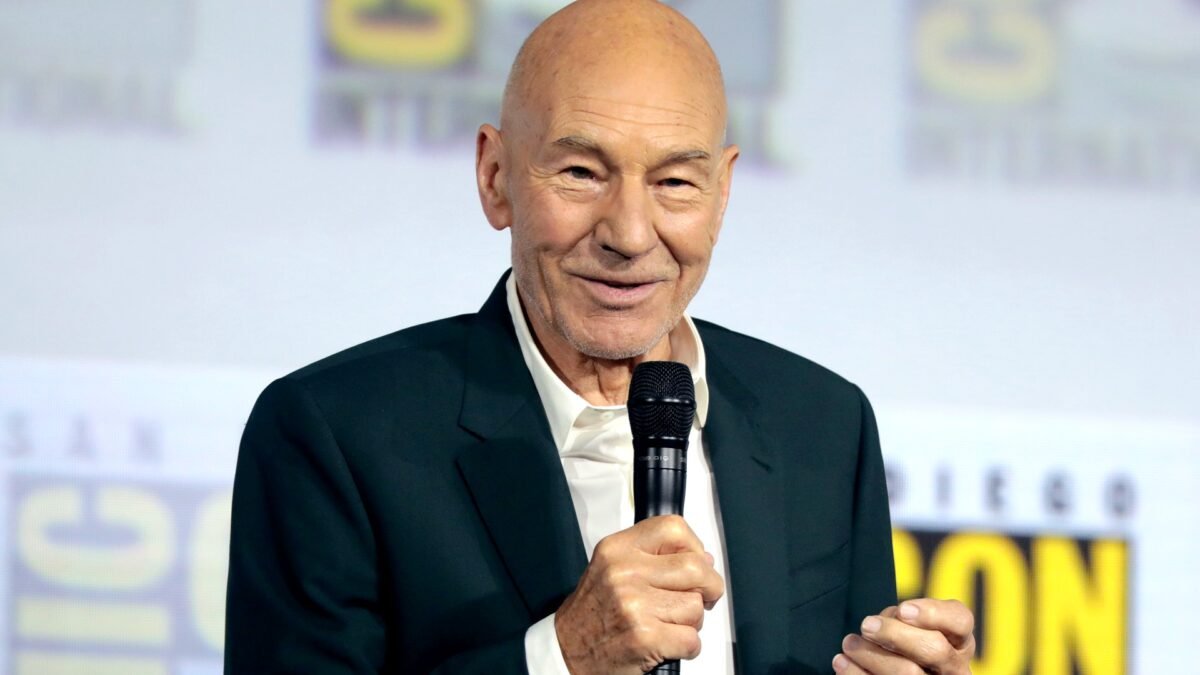 File photo (2019): Sir Patrick Stewart speaking at San Diego Comic-Con, holding a microphone.