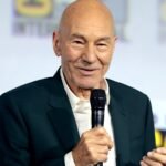 File photo (2019): Sir Patrick Stewart speaking at San Diego Comic-Con, holding a microphone.