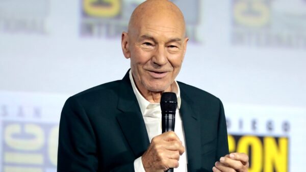 File photo (2019): Sir Patrick Stewart speaking at San Diego Comic-Con, holding a microphone.