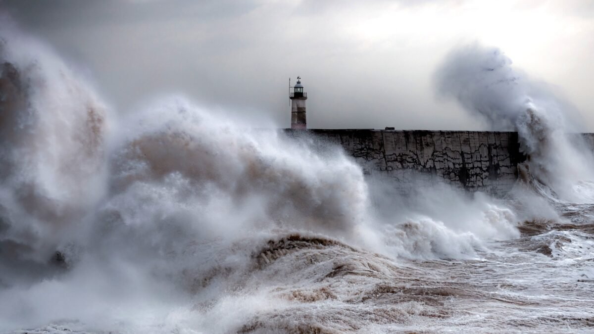 File photo: towering storm waves crashing against the breakwater and lighthouse at Newhaven Harbour, East Sussex.