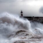 File photo: towering storm waves crashing against the breakwater and lighthouse at Newhaven Harbour, East Sussex.