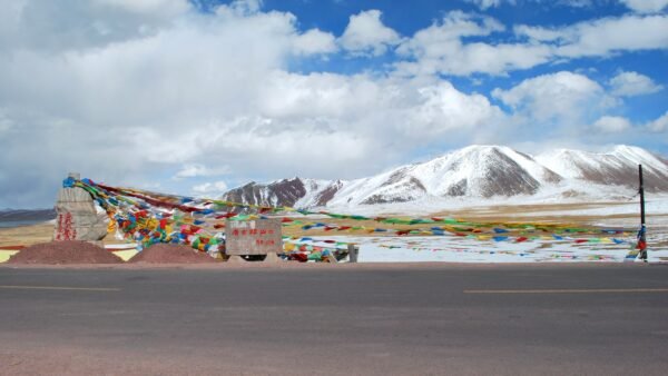 File photo: high-altitude landscape near Nagqu, Tibet, with prayer flags and snow-capped mountains.