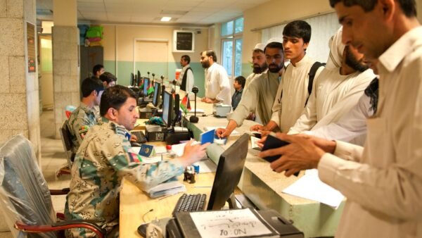 File photo: Afghan customs officials check travellers' passports at the Torkham border crossing in Nangarhar province, Afghanistan, in April 2013.