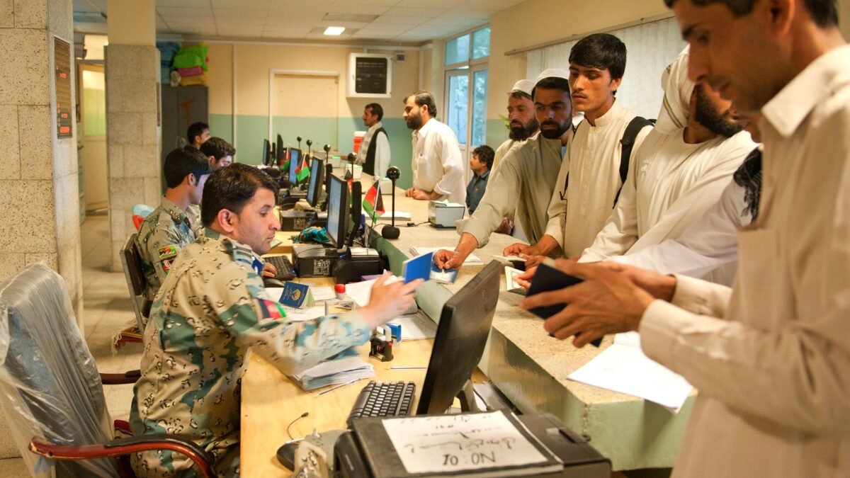 File photo: Afghan customs officials check travellers' passports at the Torkham Gate border station in Nangarhar province, Afghanistan, in April 2013.