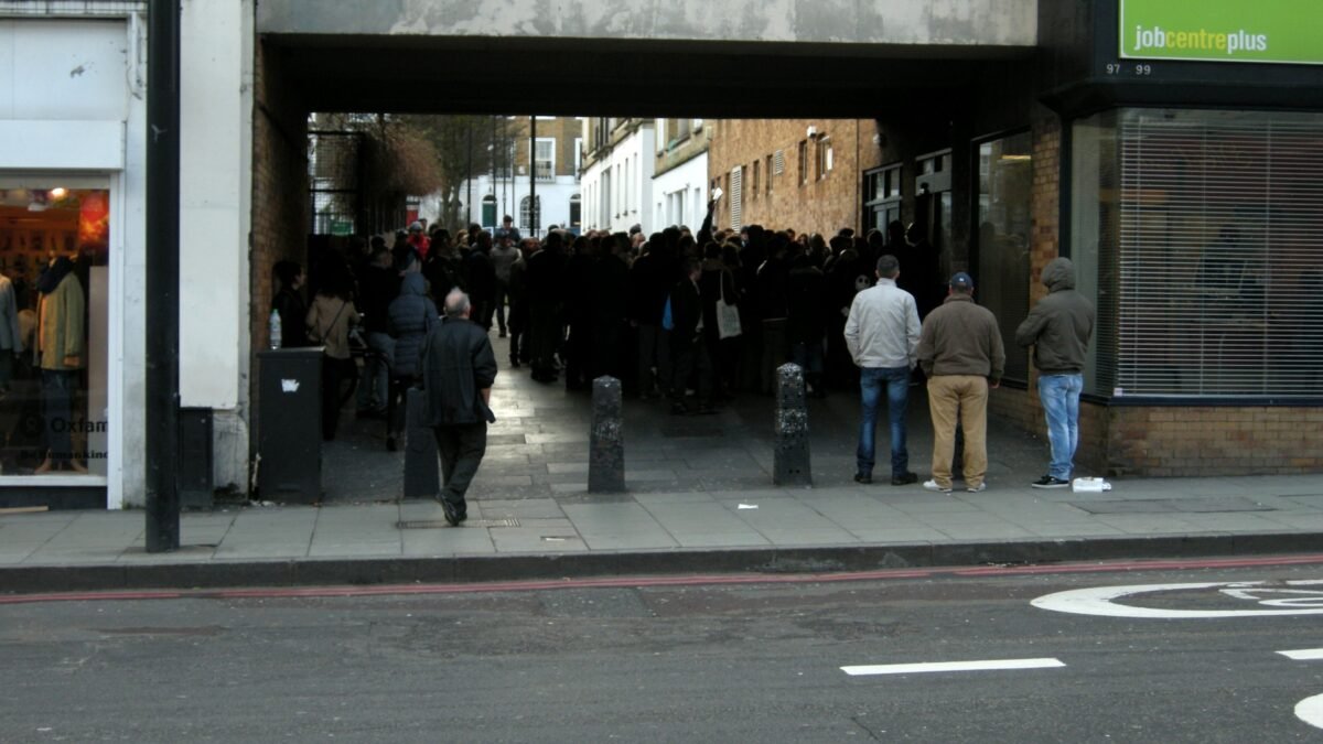Jobseekers queue outside a Jobcentre Plus office in Camden, London.