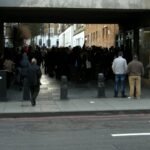 Jobseekers queue outside a Jobcentre Plus office in Camden, London.