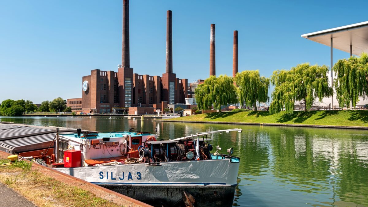 File photo: The Volkswagen plant in Wolfsburg, Germany, with its power station chimneys and the VW logo on the canal frontage.