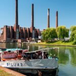 File photo: The Volkswagen plant in Wolfsburg, Germany, with its power station chimneys and the VW logo on the canal frontage.